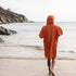 Fourth Element Tidal Change Robe made from Recycled Polyester - Orange | On the beach